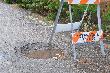 Pothole and Warning Sign